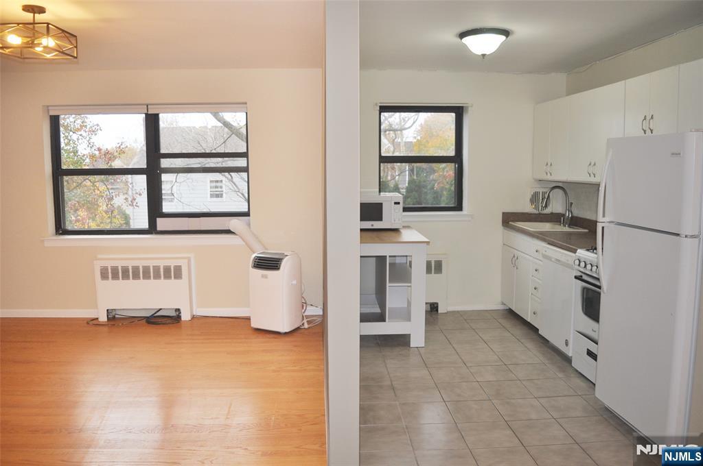 130 Orient Way, Unit 3D Rutherford, NJ 07070 - Photo 12 of 22 a kitchen with white cabinets and window
