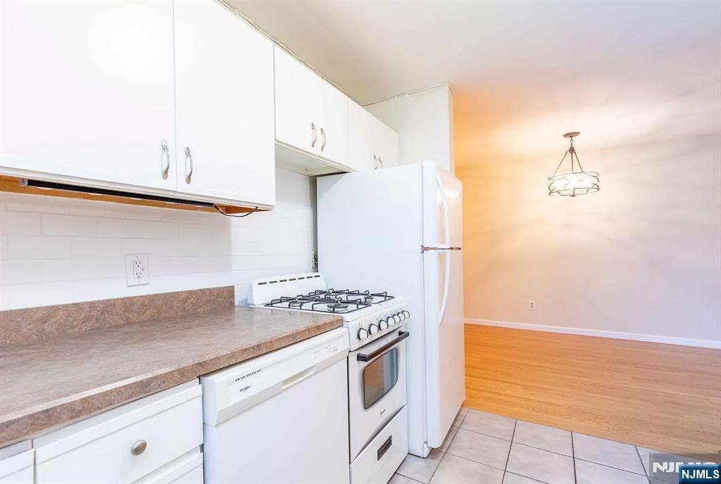 130 Orient Way, Unit 3D Rutherford, NJ 07070 - Photo 13 of 22 a kitchen with stainless steel appliances granite countertop a sink and a stove