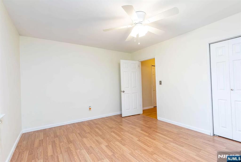 130 Orient Way, Unit 3D Rutherford, NJ 07070 - Photo 16 of 22 a view of an empty room with wooden floor