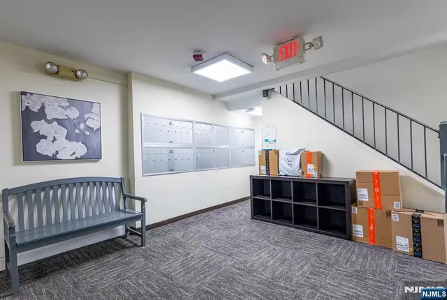 a view of a hallway with stairs and furniture
