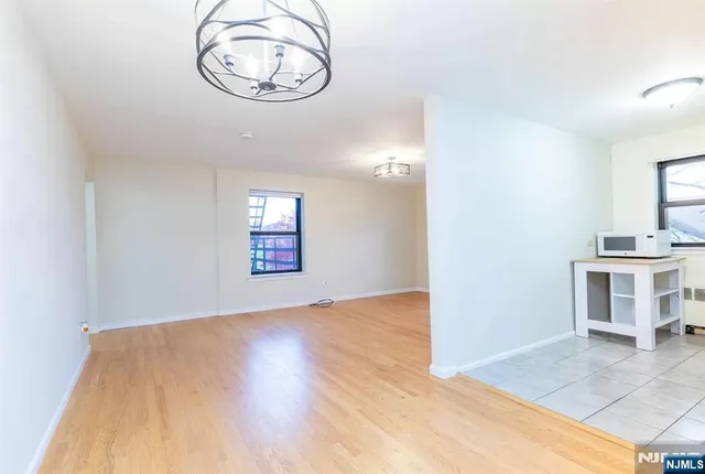 a view of a room with wooden floor and white walls