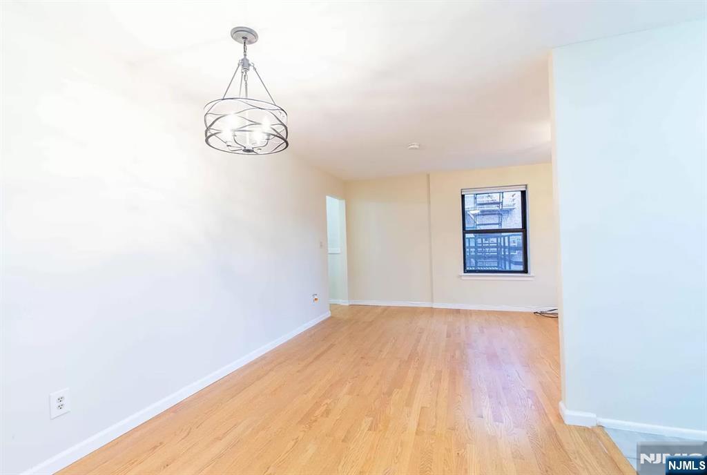 130 Orient Way, Unit 3D Rutherford, NJ 07070 - Photo 9 of 22 a view of a room with wooden floor and white walls
