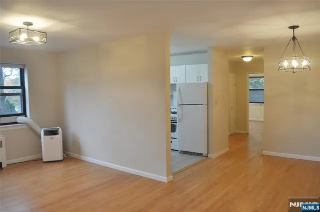 a view of a kitchen with a refrigerator a microwave and a sink