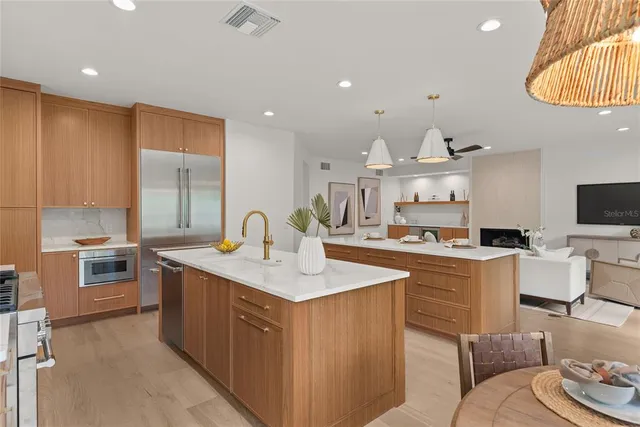 a living room with patio furniture and a large window