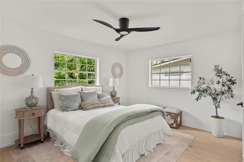 a living room with furniture a rug and white walls