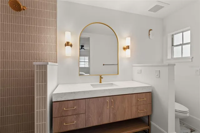 a bedroom with a large bed and a window