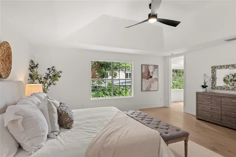 a view of a backyard house with large trees
