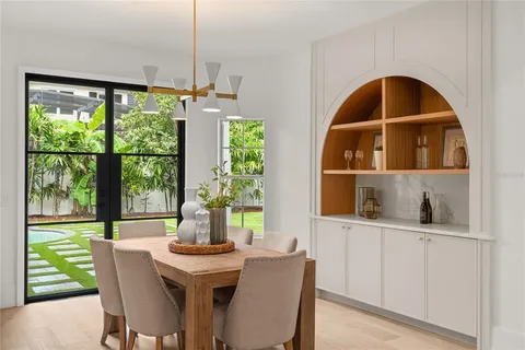 a dining room with furniture window and outside view