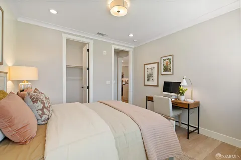 a bedroom with a bed and a desk