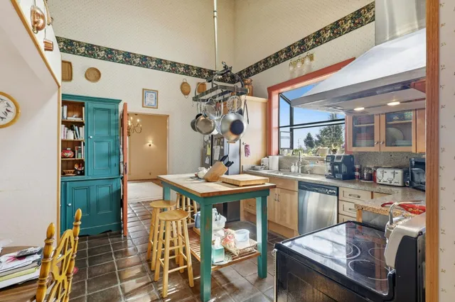 a view of a workspace with furniture and a chandelier fan