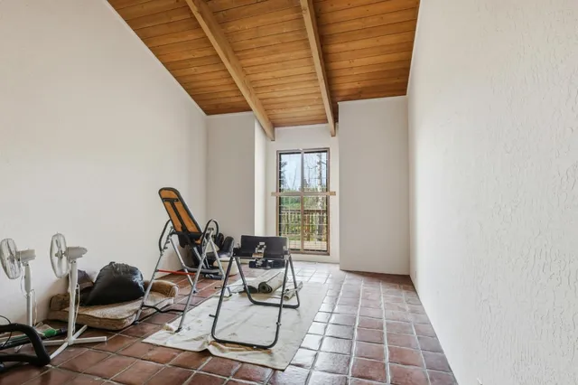 a patio with wooden fence and roof