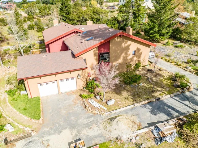 a aerial view of residential houses with yard and swimming pool