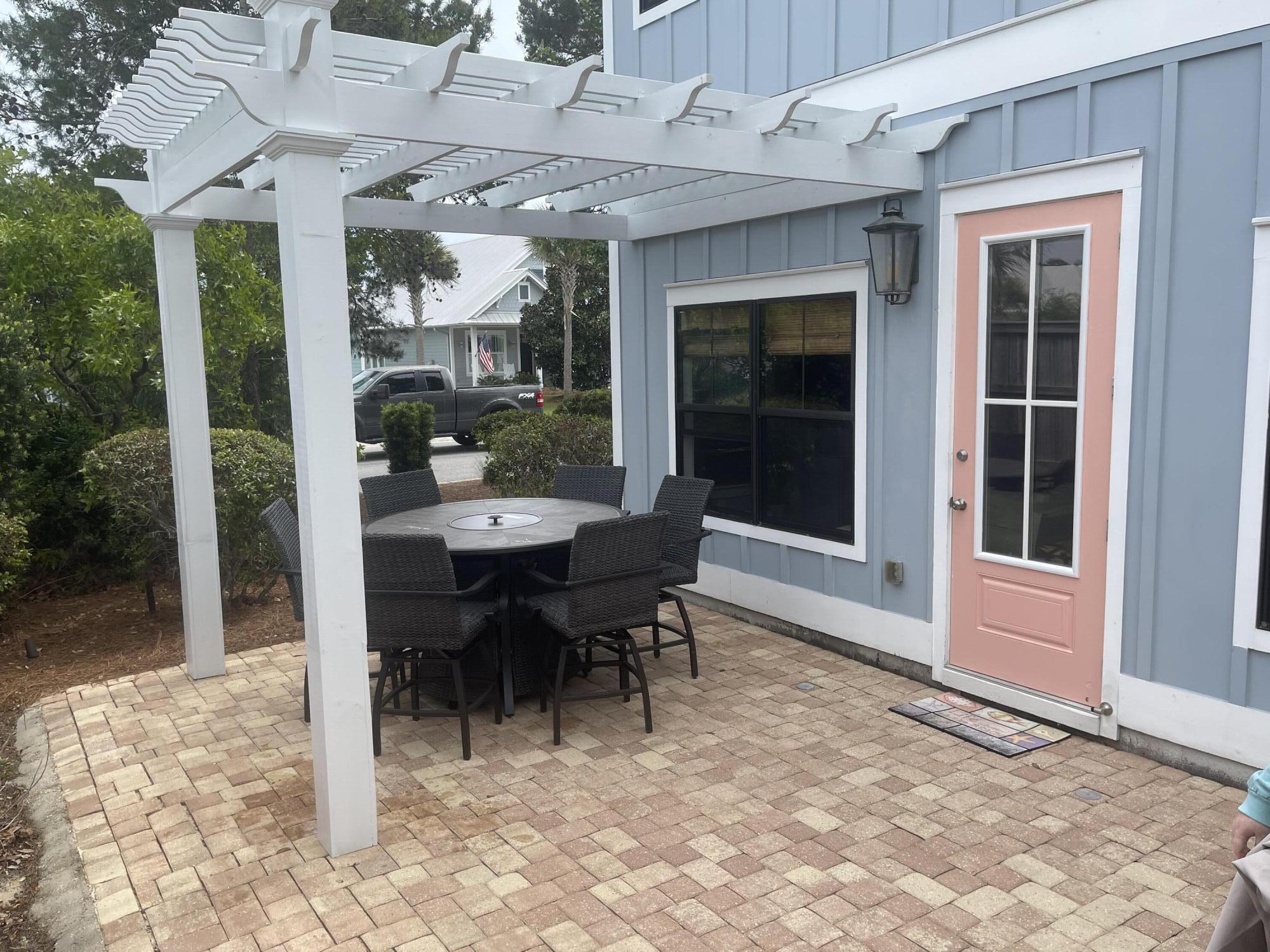 71 Emma Huggins Lane Santa Rosa Beach, FL 32459 - Photo 31 of 33 a view of a patio with table and chairs and potted plants