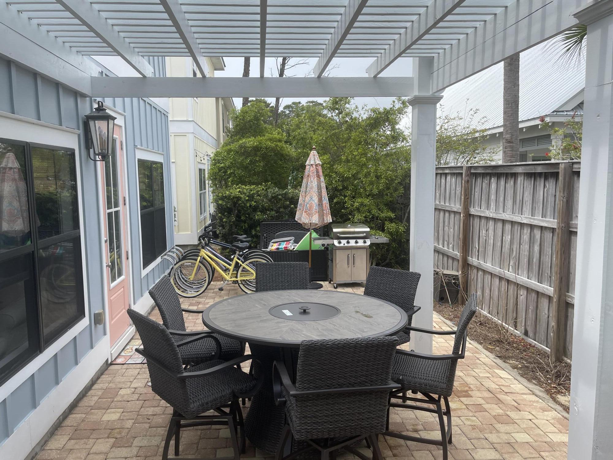 71 Emma Huggins Lane Santa Rosa Beach, FL 32459 - Photo 32 of 33 a view of a patio with a table chairs and a table