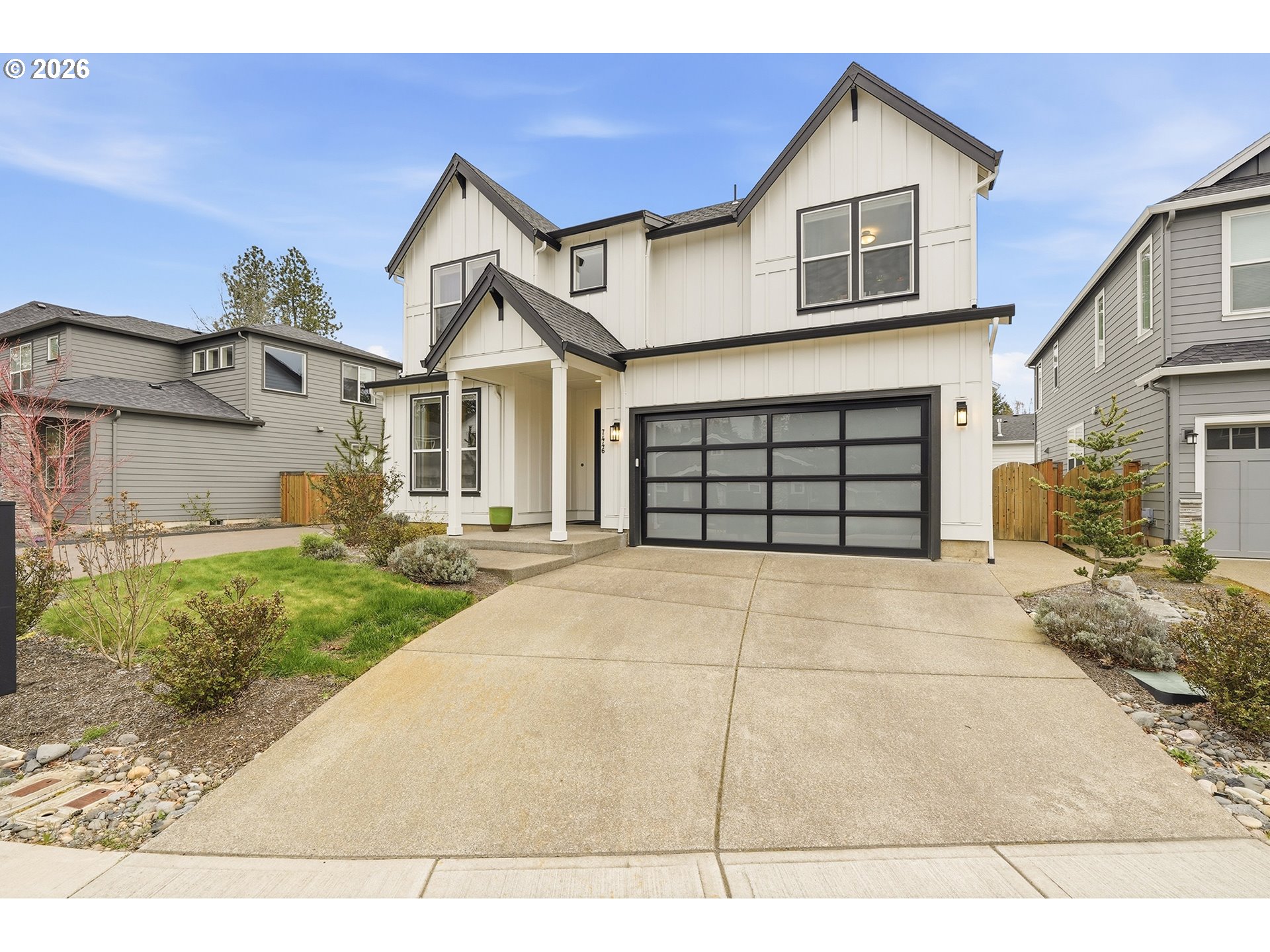 7446 Southwest 80th Terrace Portland, OR 97223 - Photo 2 of 48 a front view of a house with a yard and garage