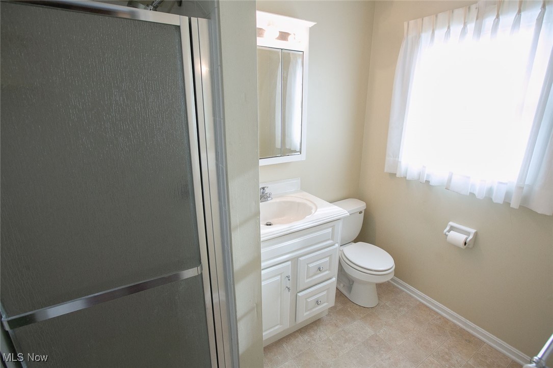 9046 River Styx Road Wadsworth, OH 44281 - Photo 26 of 30 Bathroom with tile patterned flooring, toilet, vanity, and plenty of natural light