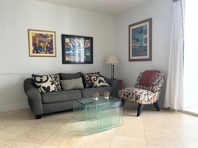 a living room with furniture flowerpot and a window
