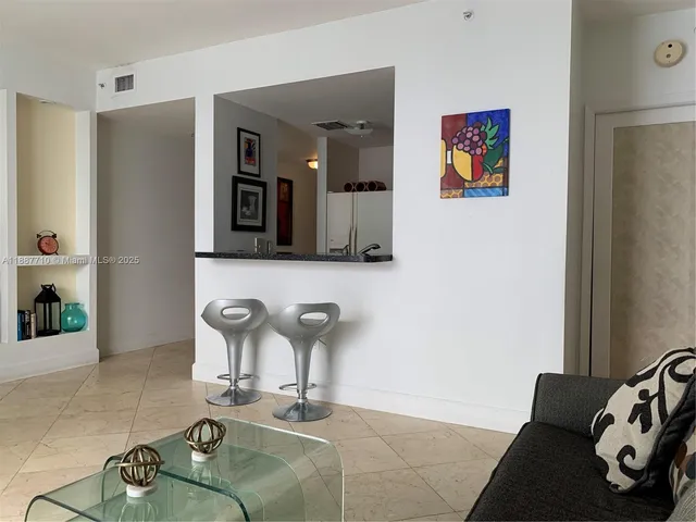 a room with two couches and painting on the wall