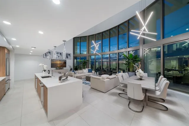 a living room with furniture a fireplace and a large window