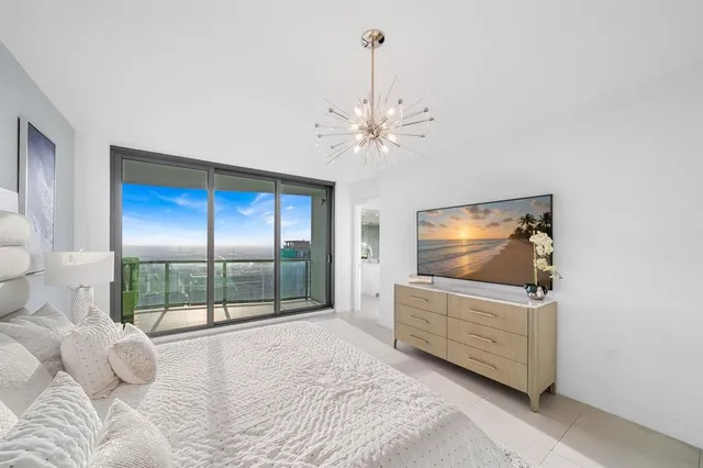a bedroom with furniture and large window