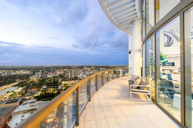 a living room with fireplace furniture and a large window