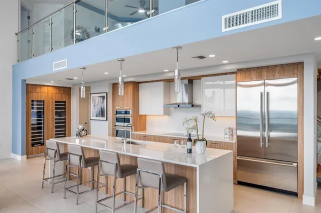 a kitchen with stainless steel appliances kitchen island granite countertop a sink and cabinets