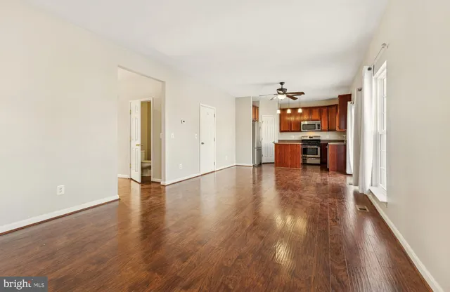 a view of a work space with wooden floor and furniture