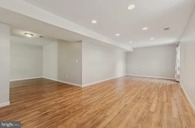 a white toilet sitting next to a bathroom sink and a mirror