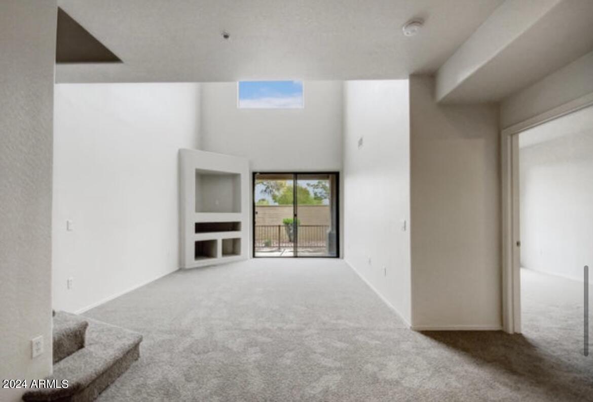 705 West Queen Creek Road, Unit 1207 Chandler, AZ 85248 - Photo 14 of 21 a view of an empty room with a fireplace and a window