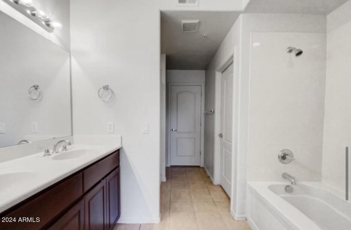 705 West Queen Creek Road, Unit 1207 Chandler, AZ 85248 - Photo 16 of 21 a bathroom with a tub sink double vanity and tub