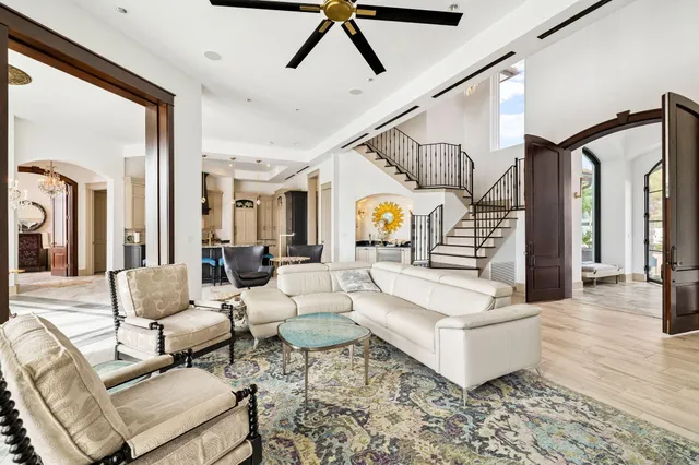 a view of a white house with a swimming pool