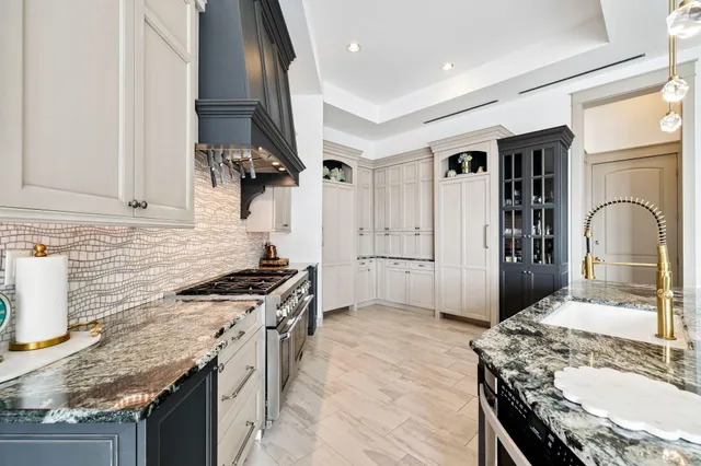 a spacious bathroom with a tub sink and mirror