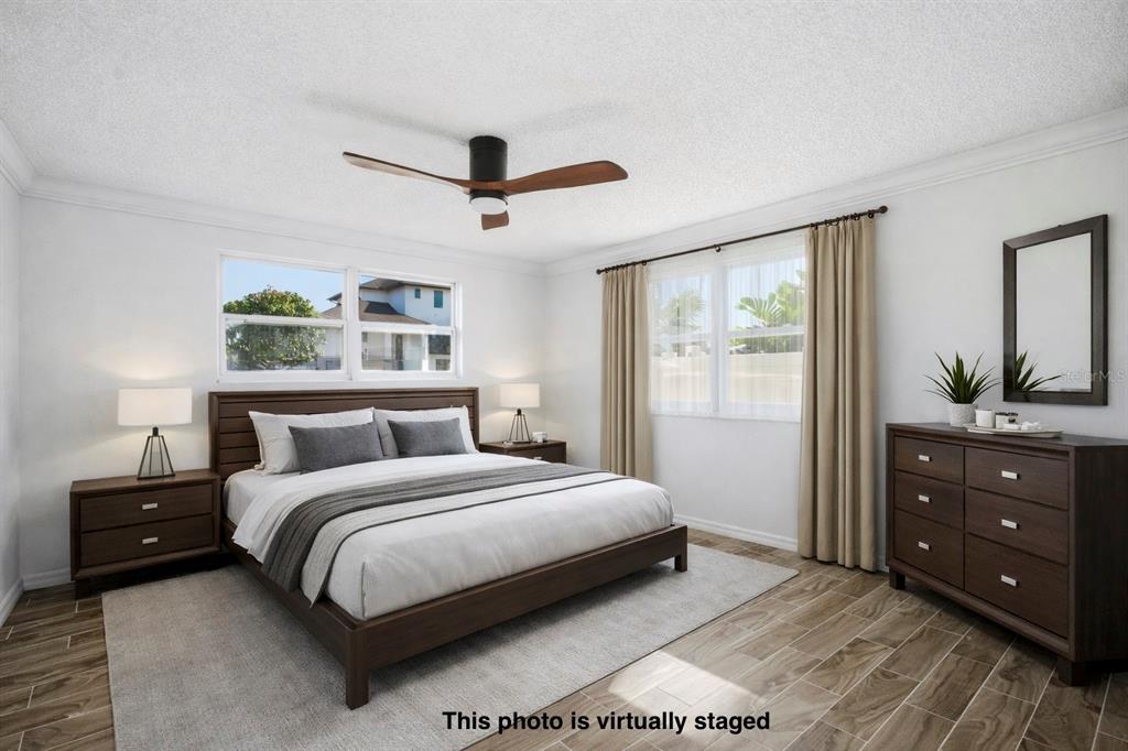 9837 Island Harbor Drive Port Richey, FL 34668 - Photo 23 of 56 a bedroom with a large bed and a window