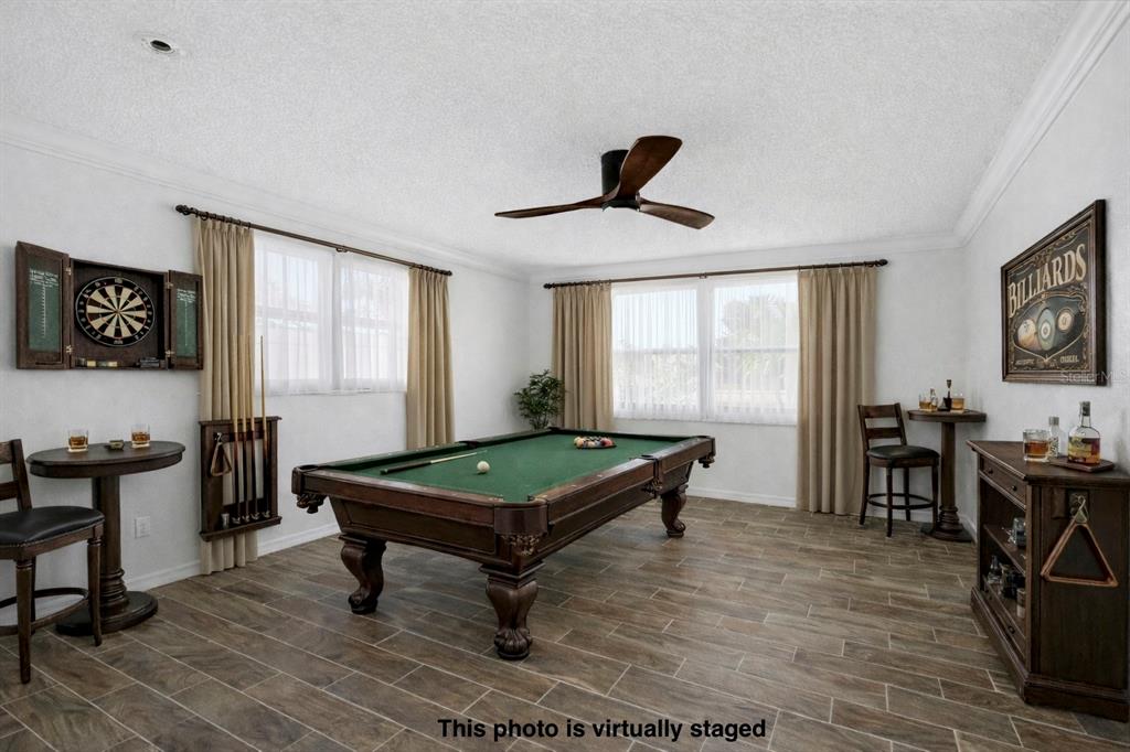 9837 Island Harbor Drive Port Richey, FL 34668 - Photo 30 of 56 a room with furniture pool table wooden floor and windows