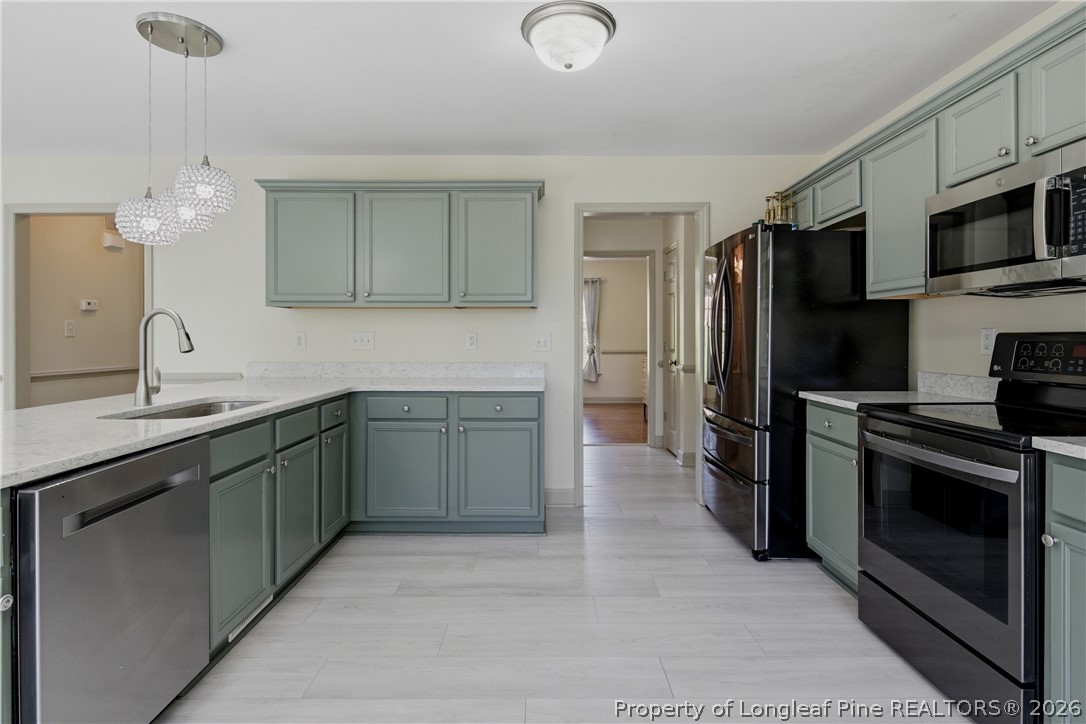 1075 Buffalo Lake Road Sanford, NC 27332 - Photo 21 of 49 a kitchen with stainless steel appliances granite countertop a refrigerator and a sink