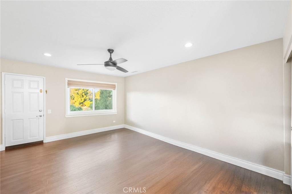 40337 Carmelita Circle Temecula, CA 92591 - Photo 23 of 65 an empty room with wooden floor and windows