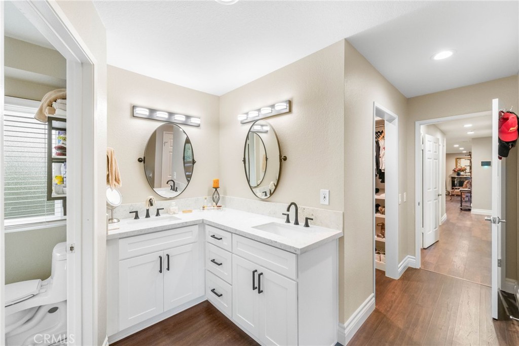 40337 Carmelita Circle Temecula, CA 92591 - Photo 27 of 65 a bathroom with a double vanity sink mirror and bathtub