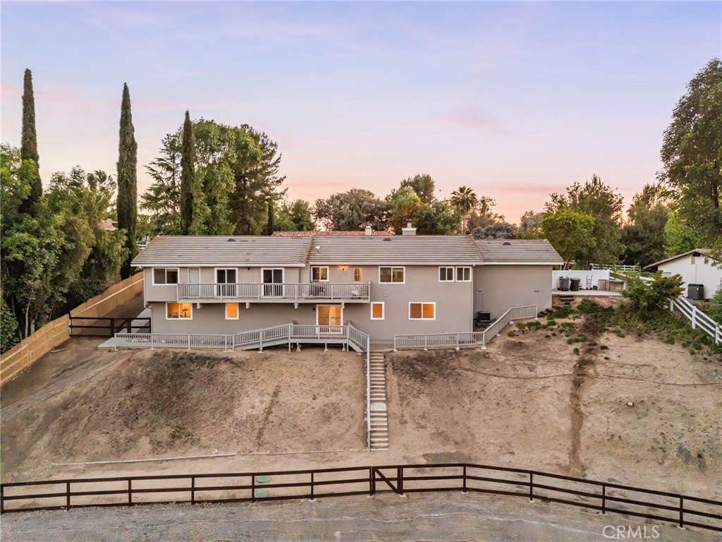 40337 Carmelita Circle Temecula, CA 92591 - Photo 57 of 65 a view of a white house next to a yard with plants and large trees