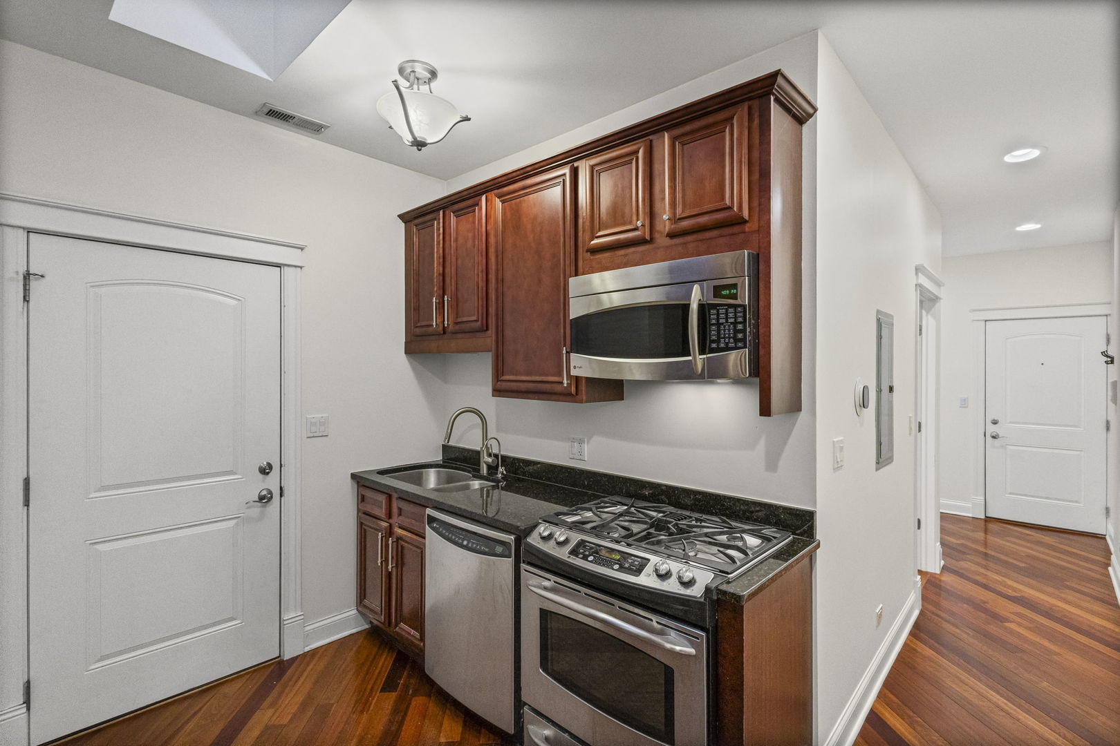 2704 West Cortland Street, Unit 3 Chicago, IL 60647 - Photo 11 of 24 a kitchen with stainless steel appliances granite countertop a stove and a refrigerator