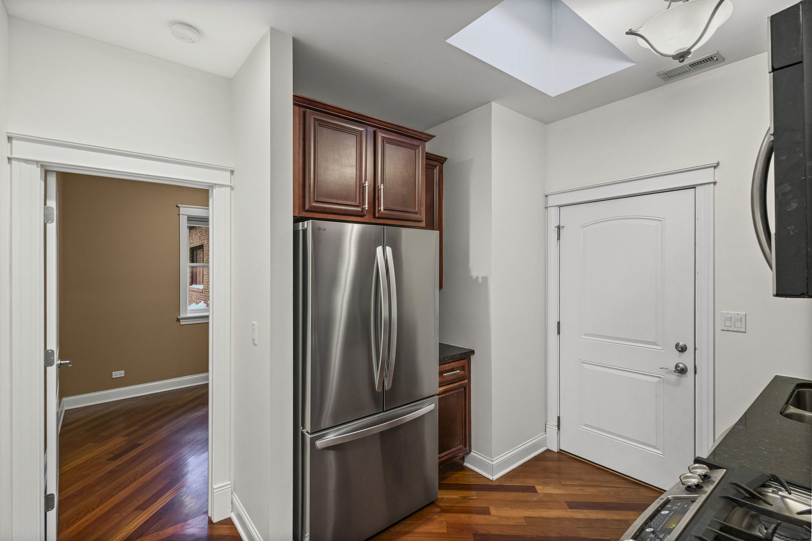 2704 West Cortland Street, Unit 3 Chicago, IL 60647 - Photo 12 of 24 a view of a refrigerator in kitchen and an empty room