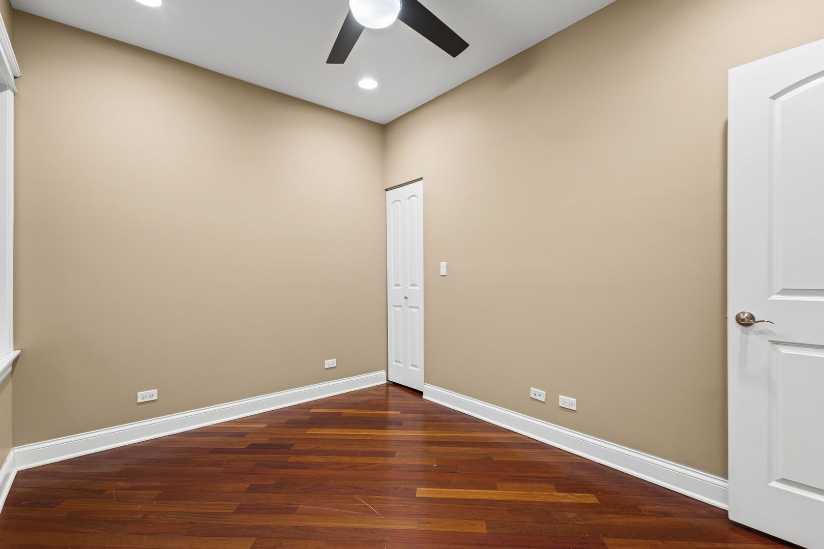 2704 West Cortland Street, Unit 3 Chicago, IL 60647 - Photo 13 of 24 an empty room with wooden floor and ceiling fan