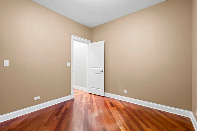 a view of room with wooden floor