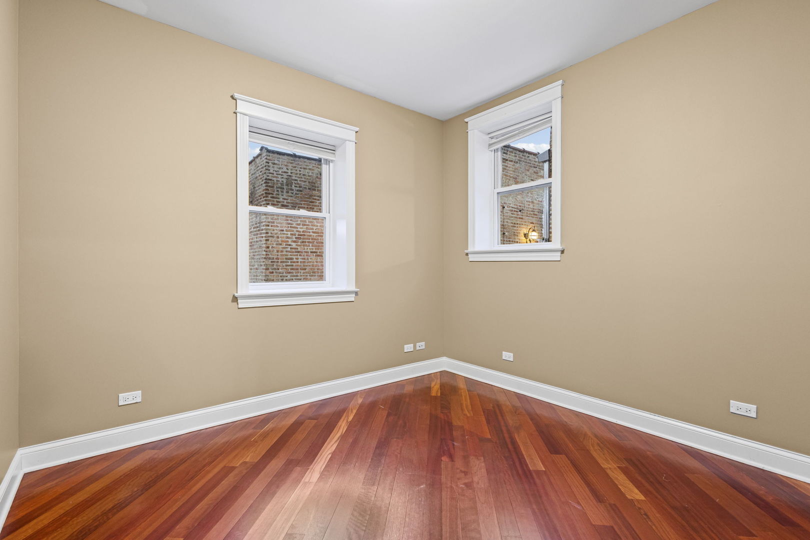 2704 West Cortland Street, Unit 3 Chicago, IL 60647 - Photo 16 of 24 a view of an empty room with wooden floor and a window
