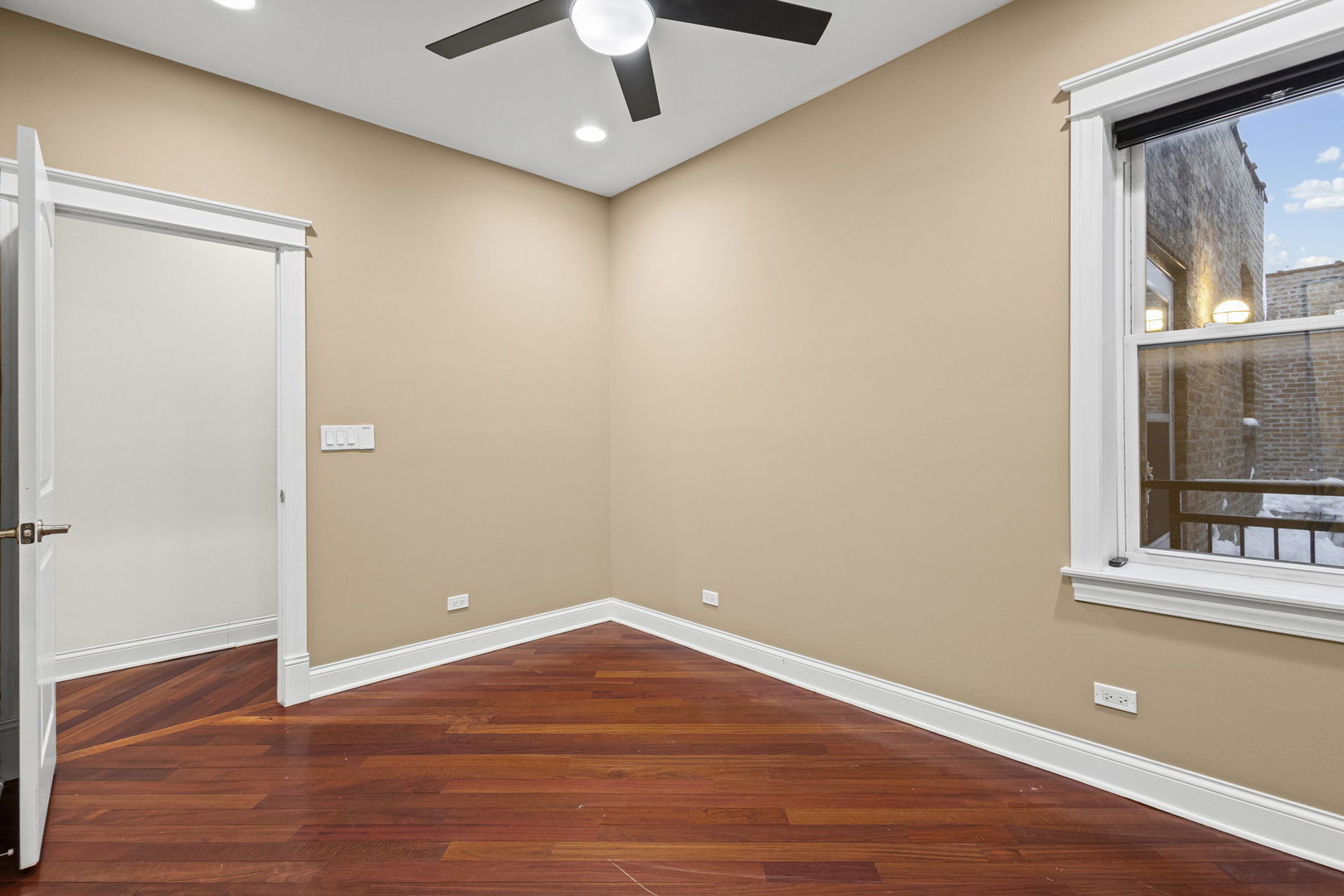 2704 West Cortland Street, Unit 3 Chicago, IL 60647 - Photo 17 of 24 an empty room with wooden floor and windows