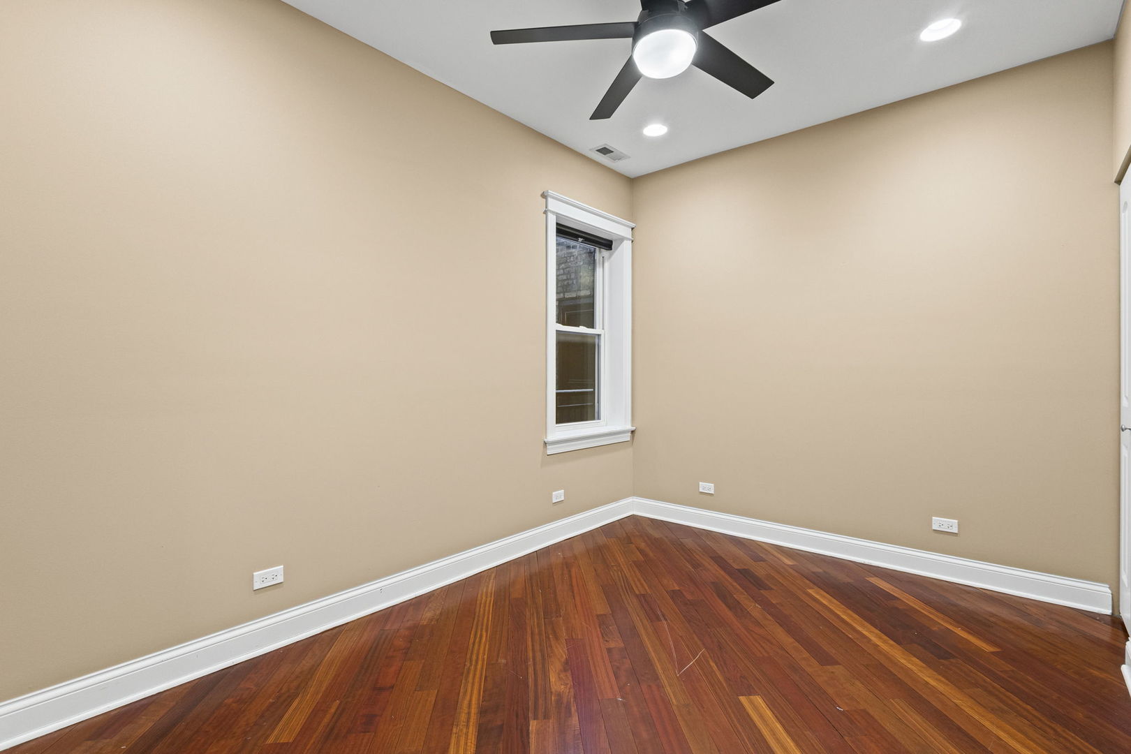 2704 West Cortland Street, Unit 3 Chicago, IL 60647 - Photo 18 of 24 an empty room with wooden floor and windows