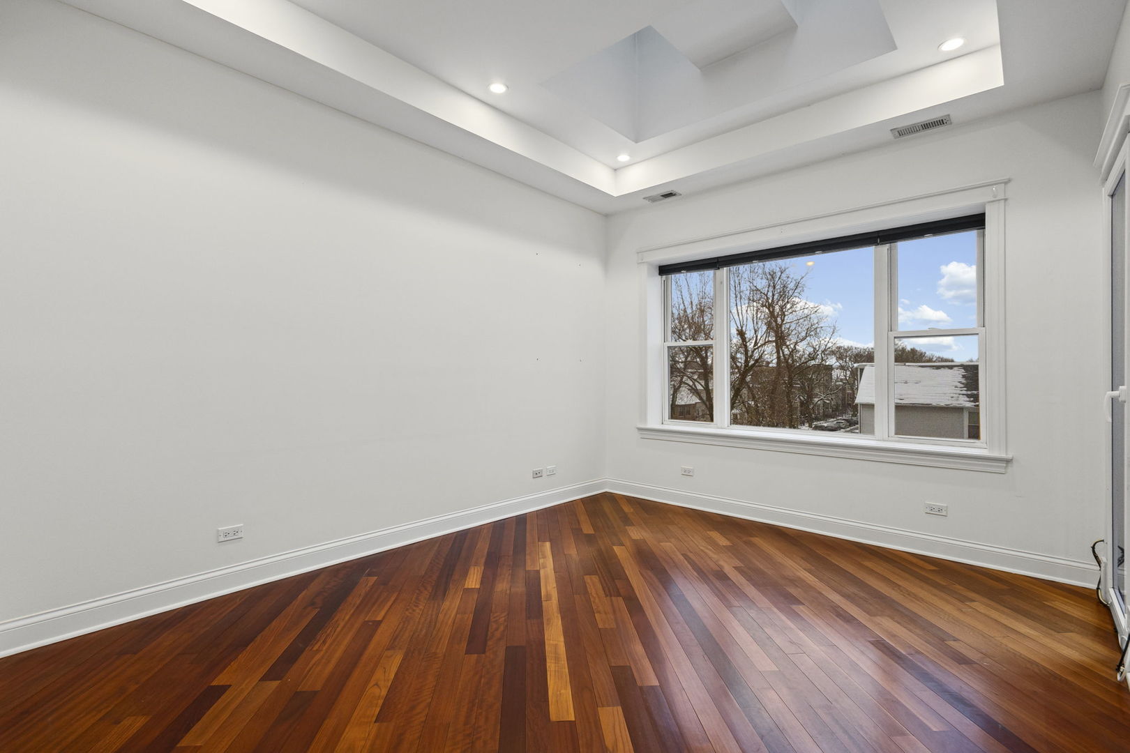 2704 West Cortland Street, Unit 3 Chicago, IL 60647 - Photo 9 of 24 a view of an empty room with wooden floor and a window