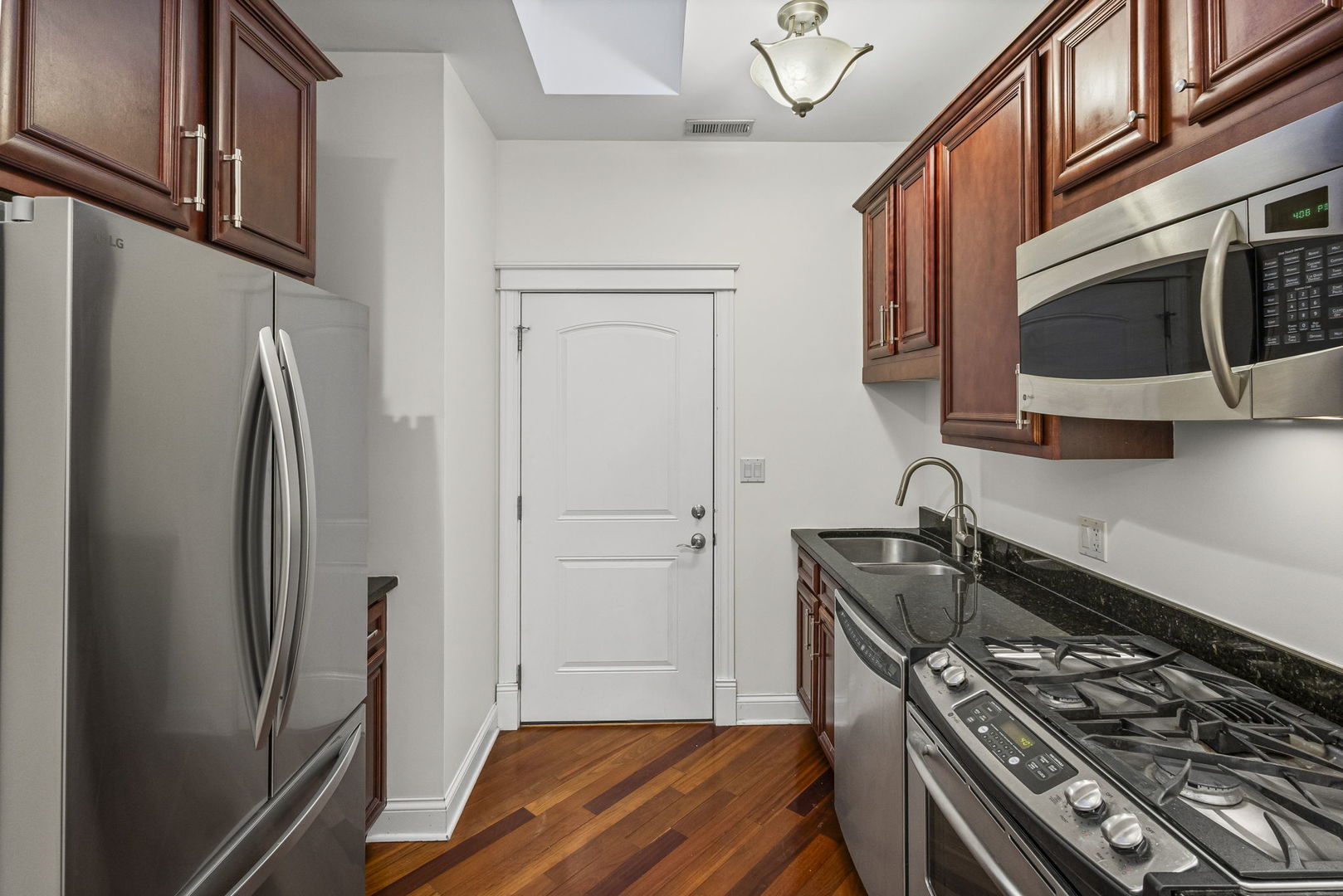 2704 West Cortland Street, Unit 3 Chicago, IL 60647 - Photo 10 of 24 a kitchen with stainless steel appliances granite countertop a refrigerator and a stove top oven