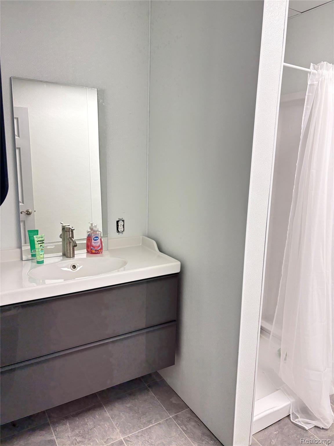 3041 Reeder Road Clarkston, MI 48346 - Photo 15 of 22 Bathroom with vanity, a stall shower, and light tile patterned flooring
