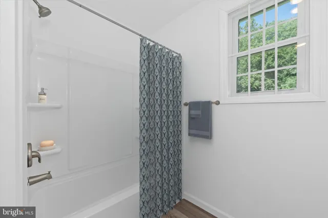 a bathroom with a shower and a bathtub