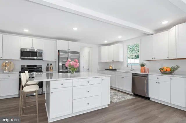 a kitchen with white cabinets and white appliances